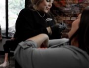 Piercing shop near me showing a piercer at american tattoo society of Fayetteville Ft Bragg pierces a client off base